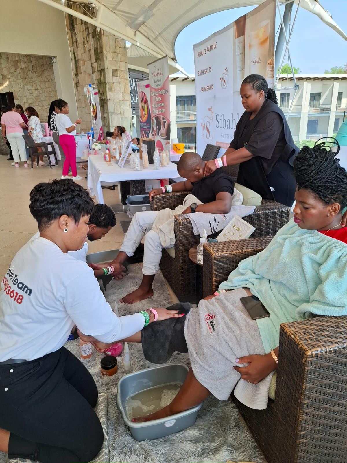 Sibahle team pampering guests with foot soaks at a wellness event
